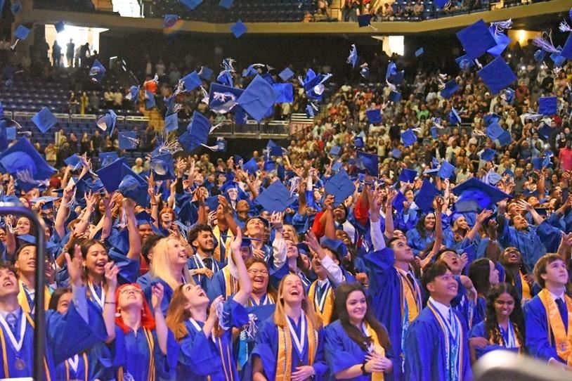 picture of HS grads throwing caps